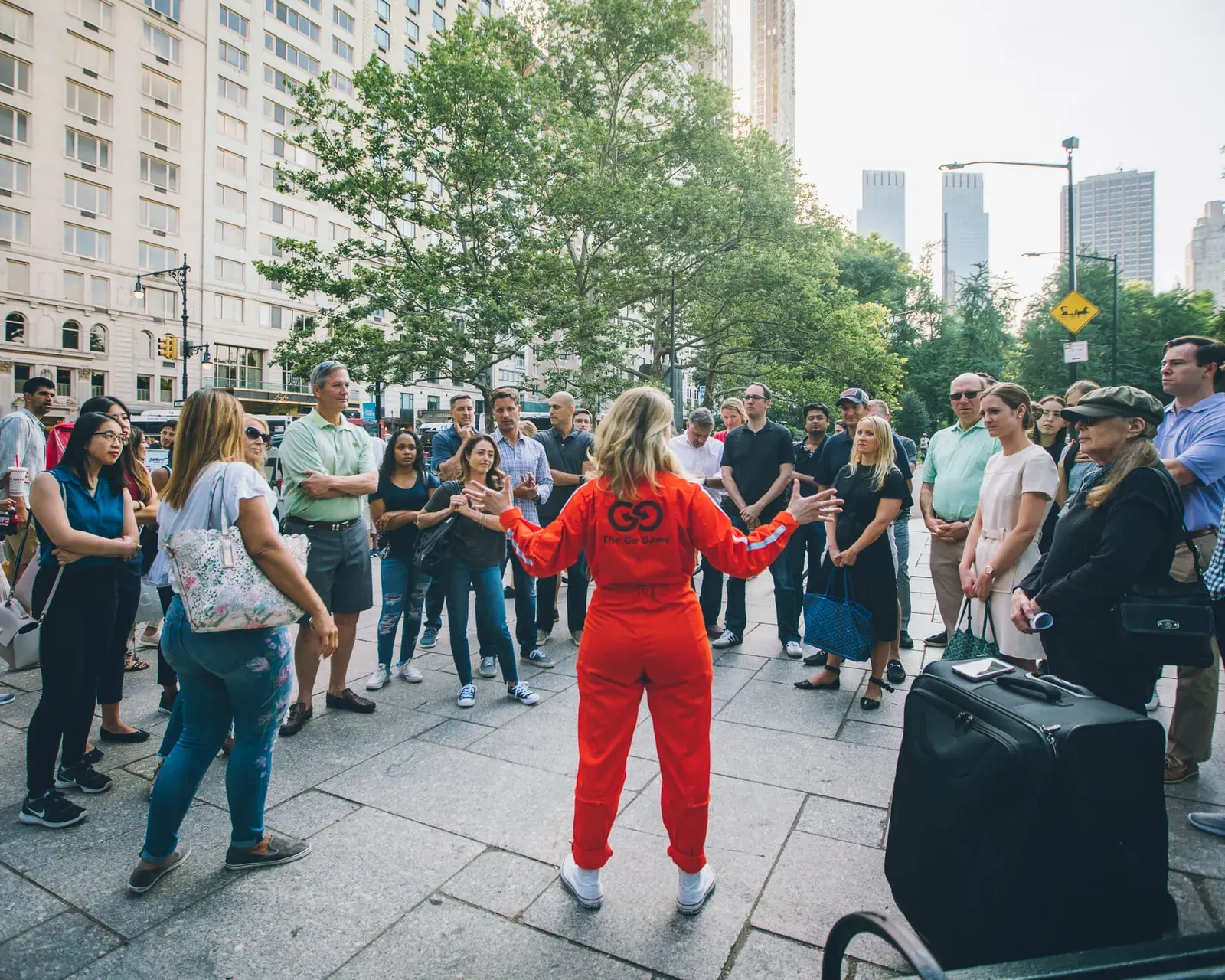 The Go Game host leading a team building experience in a city plaza