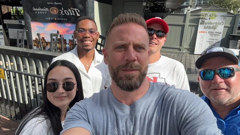 LandSea Homes teammates take an outdoor group selfie during their downtown Orlando Classic Adventure.